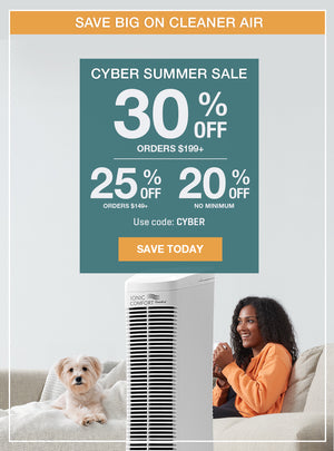 Cyber Summer Sale.  Image features a woman sitting on a couch next to a small white dog, with the IONIC Comfort air purifier.